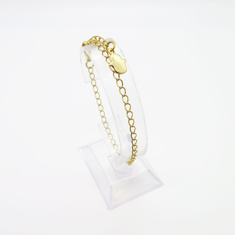 Ce bracelet doré accompagné d'une Main de Myriam (Hamsa) couleur or, saura vous protéger contre le mauvais œil tout en se montrant discret grâce à sa forme épurée.